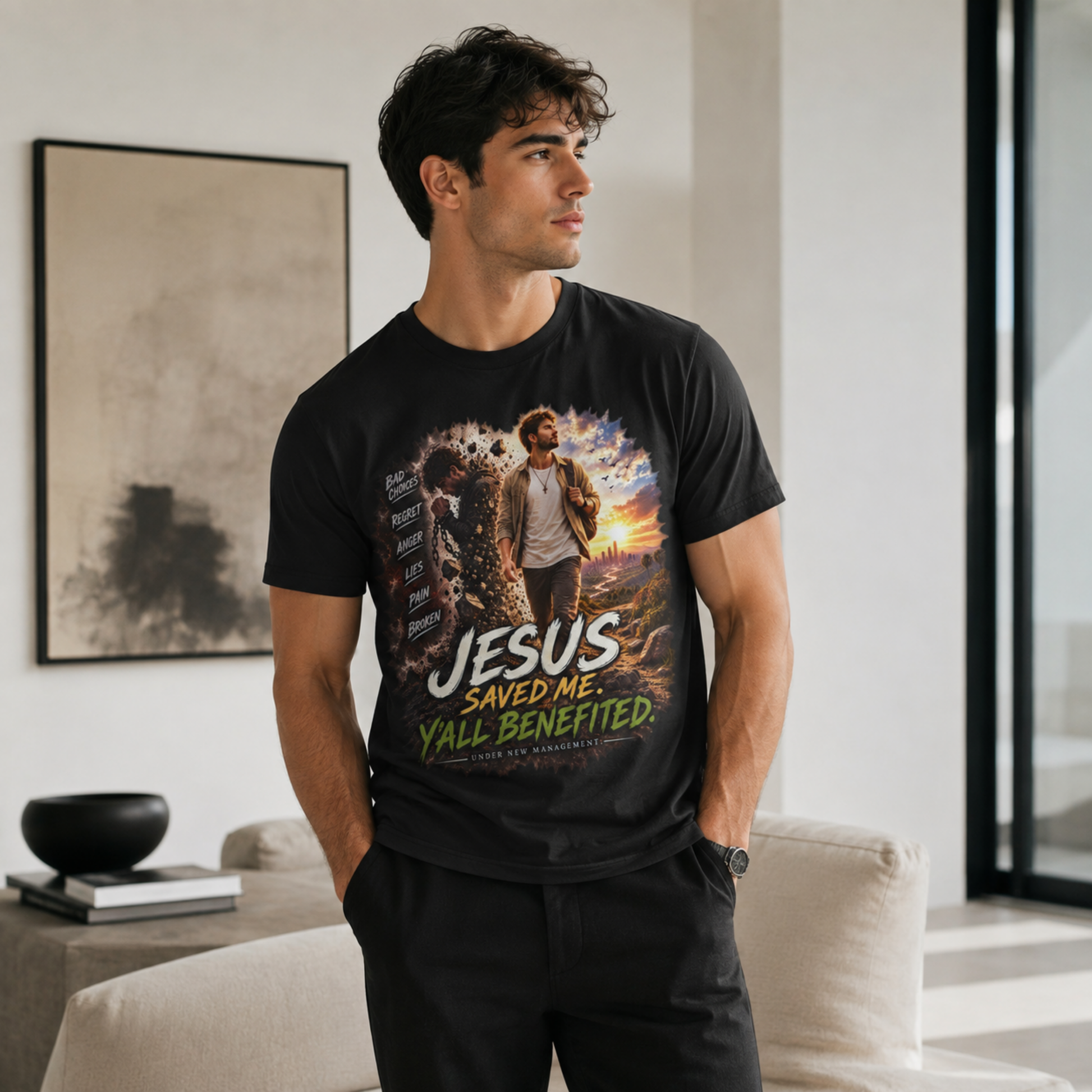 A man wearing a black graphic t-shirt with a colorful print of Jesus walking on water and the text 'JESUS SAVED ME. Y'ALL BENEFITED.